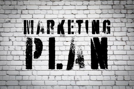 Marketing plan concept. Painted text on a brick wallの写真素材