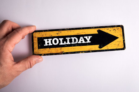 Holiday Concept. Pointing arrow with text and a mans hand on a white background
