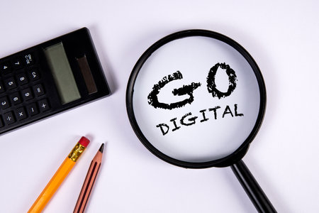 Go Digital. Magnifying glass and calculator on white backgroundの写真素材