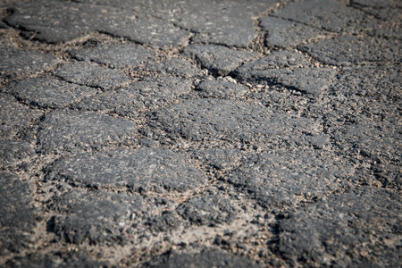 Asphalt road texture background. Damaged, cracked and pittedの写真素材