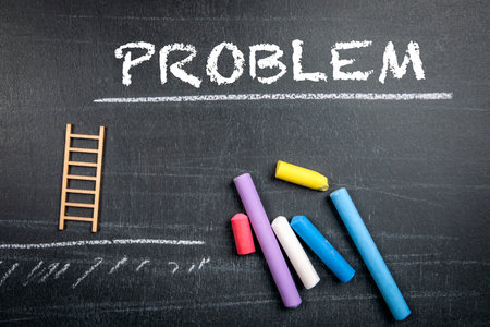 PROBLEM. Colored pieces of chalk on a dark chalkboard