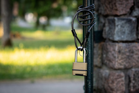 Open metal territory gate. Padlock with chain