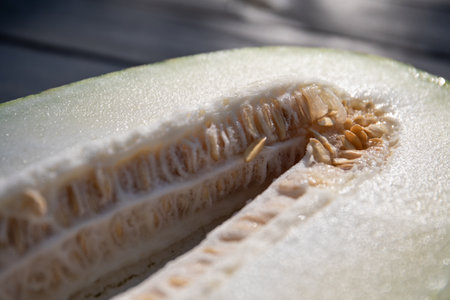 Half of a juicy melon close-up, melon seeds in the middle