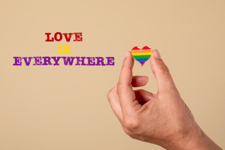 Love is everywhere. Miniature heart in a womans hand on a light background