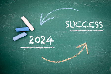 2024 and SUCCESS Concept. Colored pieces of chalk on a green boardの写真素材