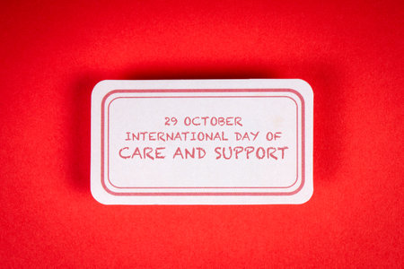 International Day of Care and Support 29 October. Sticky note with text on a red backgroundの写真素材