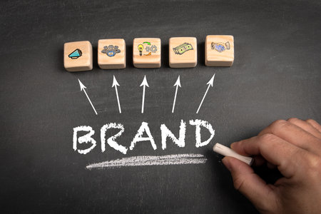 BRAND Concept. Text and wooden blocks on a chalkboard backgroundの写真素材