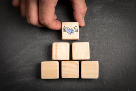 Transaction, Agreement concept. Wooden blocks on a chalkboard backgroundの写真素材