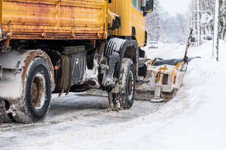 A snowplow is shoveling snow on the street, severe winter with lot of snow