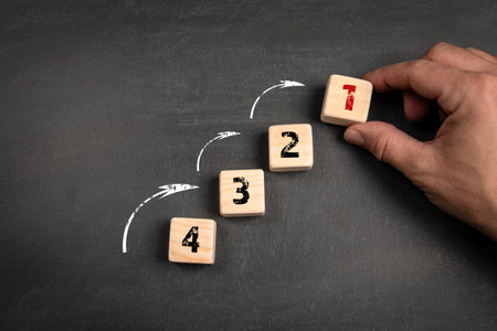 Competition and development concept. Wooden blocks on a dark chalkboard background