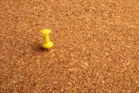 A close up shot of a notice board with yellow pinの写真素材