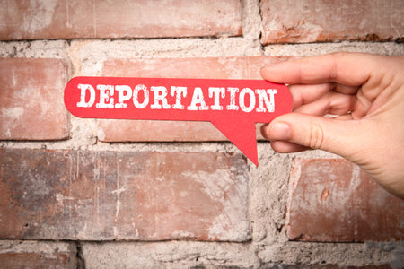 Deportation. Red speech bubble with text on a red brick backgroundの写真素材