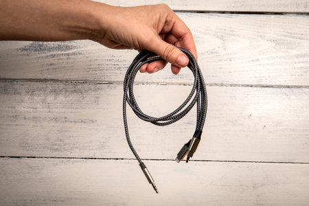 3 In 1 Type-C3.5mm Jack Aux Cable in hand. White backgroundの写真素材