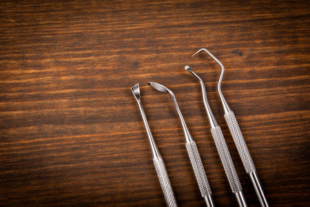 Dentist and dental hygienist tools on a dark wooden backgroundの写真素材