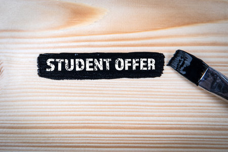 Student Offer Concept. Black paint and brush on wood texture backgroundの写真素材