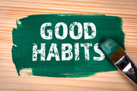 Good Habits. Text, green color and paint brush on wood texture backgroundの写真素材