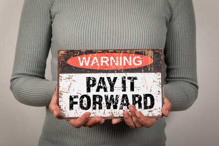 Pay It Forward. Warning sign with text woman in hand