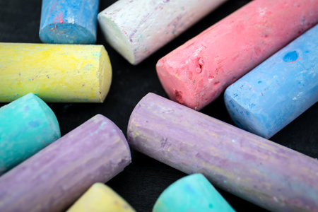 Large pieces of coloured chalk on a dark wood backgroundの写真素材