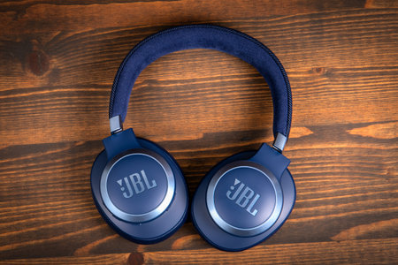 Headphones bluetooth JBL Live JBLT770NCBLU on a wooden texture background