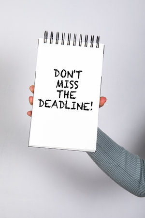 Dont miss the deadline. Notepad with text in womans handの写真素材