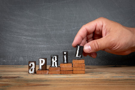 APRIL. Wooden letters, alphabet blocks on steps. development and growth conceptの写真素材