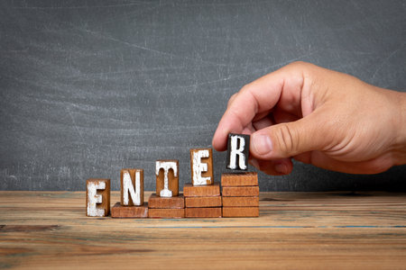 ENTER. Wooden letters, alphabet blocks on steps. development and growth conceptの写真素材