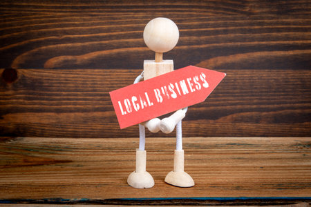 Local Business. Red pointing arrow with text. Miniature human figuresの写真素材