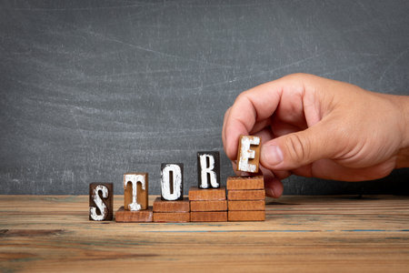 STORE. Wooden letters, alphabet blocks on steps. development and growth conceptの写真素材