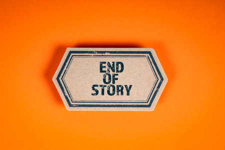 End Of Story. Cardboard sticker with text on an orange backgroundの写真素材