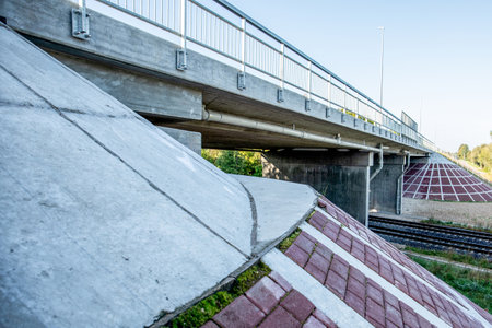 Road overpass with water drains over railway tracks, view from belowの写真素材