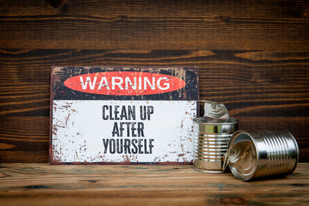 Clean up after yourself. Warning sign with text on wooden backgroundの写真素材