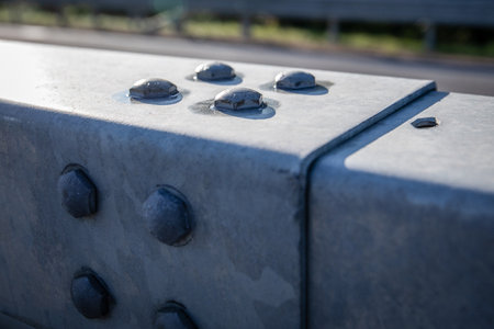 Close-up of large metal screws on tin cover, engineering solutionsの写真素材