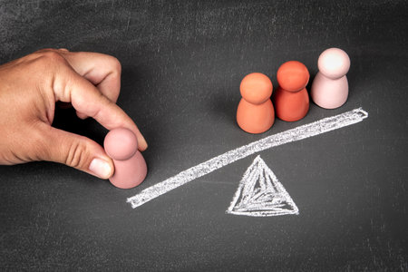 Victory and influence concept. Wooden human figures on a chalkboard backgroundの写真素材