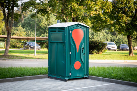 Green mobile toilet in the car parking outdoors, a temporary solutionの写真素材