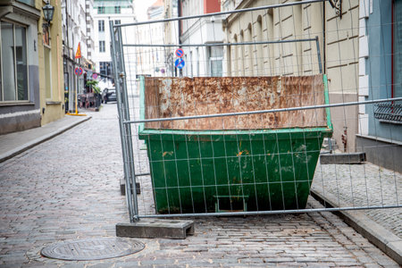 Green construction waste container in the old town