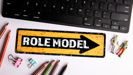 Role Model. Text on yellow arrow. Computer keyboard on the office tableの写真素材