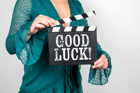 Good Luck. Female hands holding movie clapperの写真素材
