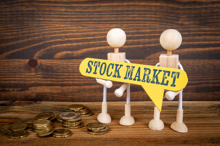 Stock Market Concept. Yellow speech bubble with text. Miniature human figuresの写真素材