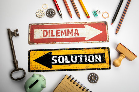 Dilemma and Solution Concept. Red and yellow directional arrow with text on a white office desk
