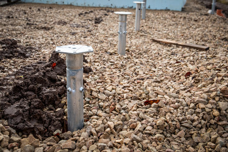 Hot-dip galvanized screw piles screwed into the ground. Abandoned constructionの写真素材