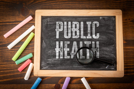 PUBLIC HEALTH. Miniature blackboard on a wooden texture backgroundの写真素材
