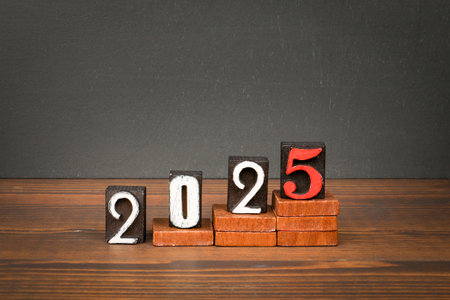 2025 growth and review concept. Blocks on wooden texture table
