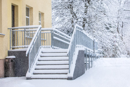 Icy and snow-covered entrance stairs. Metal structureの写真素材