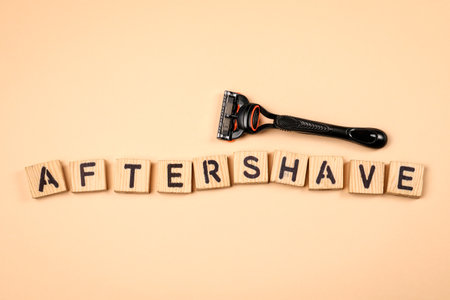 AFTERSHAVE text made from wooden alphabet letters on a light background