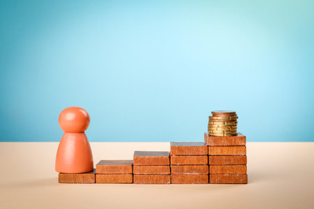 Wooden steps with coins on the top step. A concept of profit-making and investment