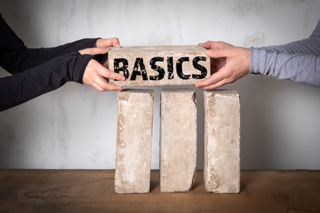 Basics Concept. Stack of white bricks on a wooden table