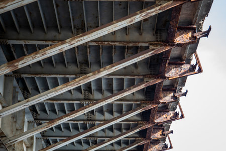 Rusty Bridge Understructure with Metal Beams and Weathered Steel Supports