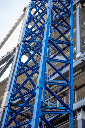 Blue Construction Crane Tower and Framework with Building in Backgroundの写真素材