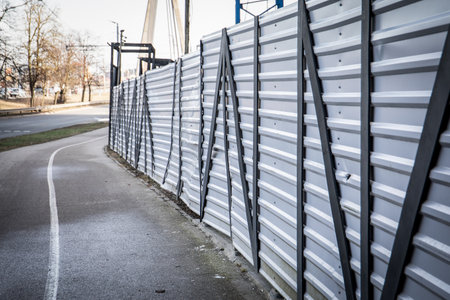 White Temporary Construction Fence Along Roadwayの写真素材