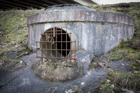 Rusty Drainage Pipe with Metal Grate in Natural Settingの写真素材